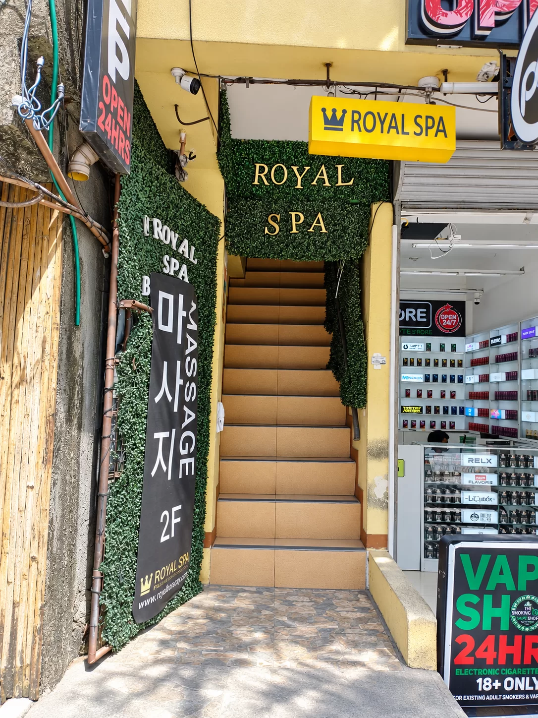 Yellow Royal Spa sign and stairs to the second-floor entrance